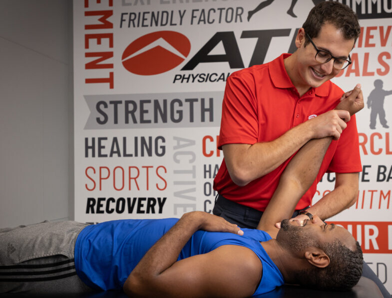 Man receiving physical therapy on his shoulder