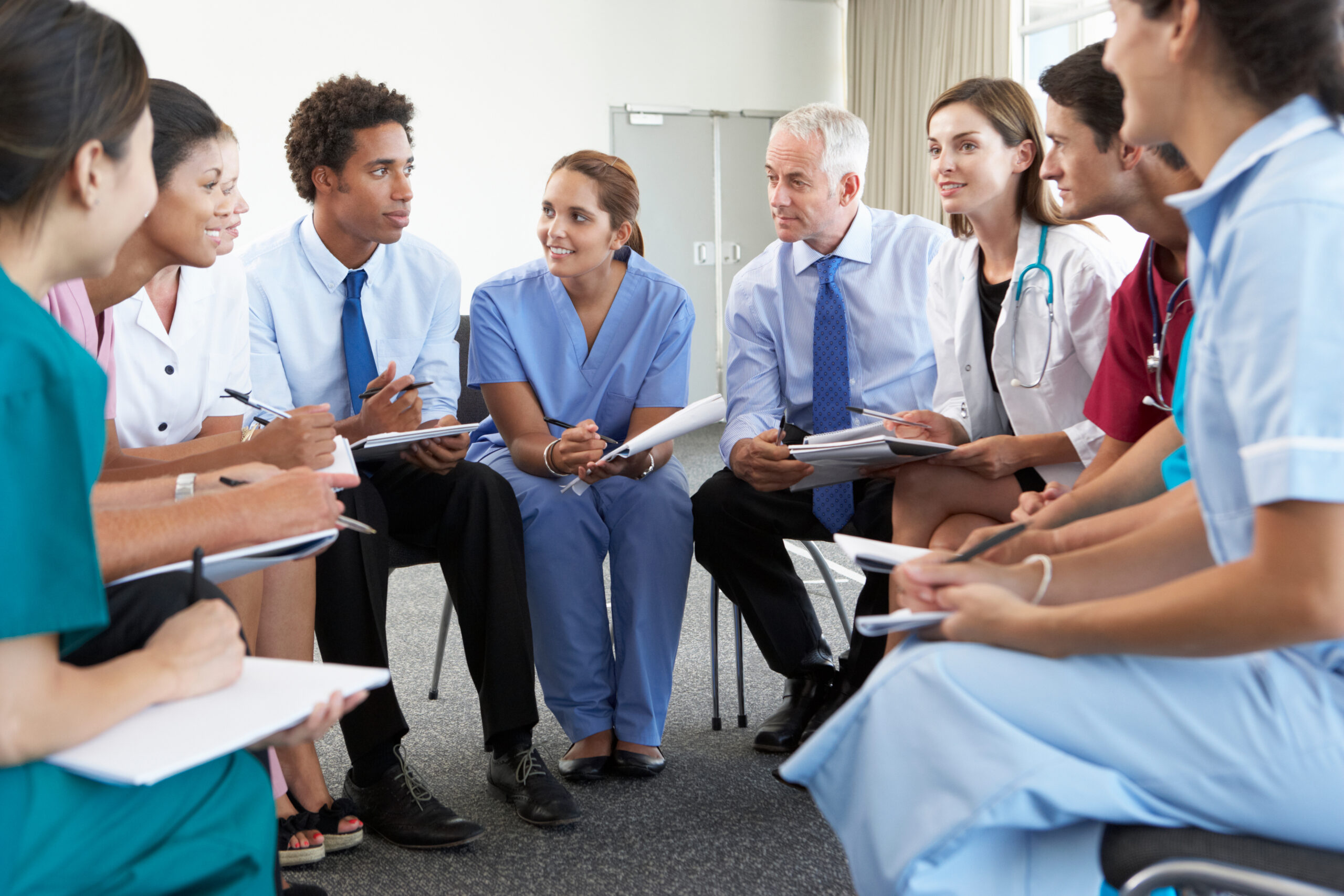 Medical Staff Seated In Circle At Case Meeting