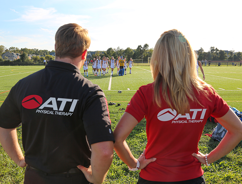 Athletic trainers watching a team play